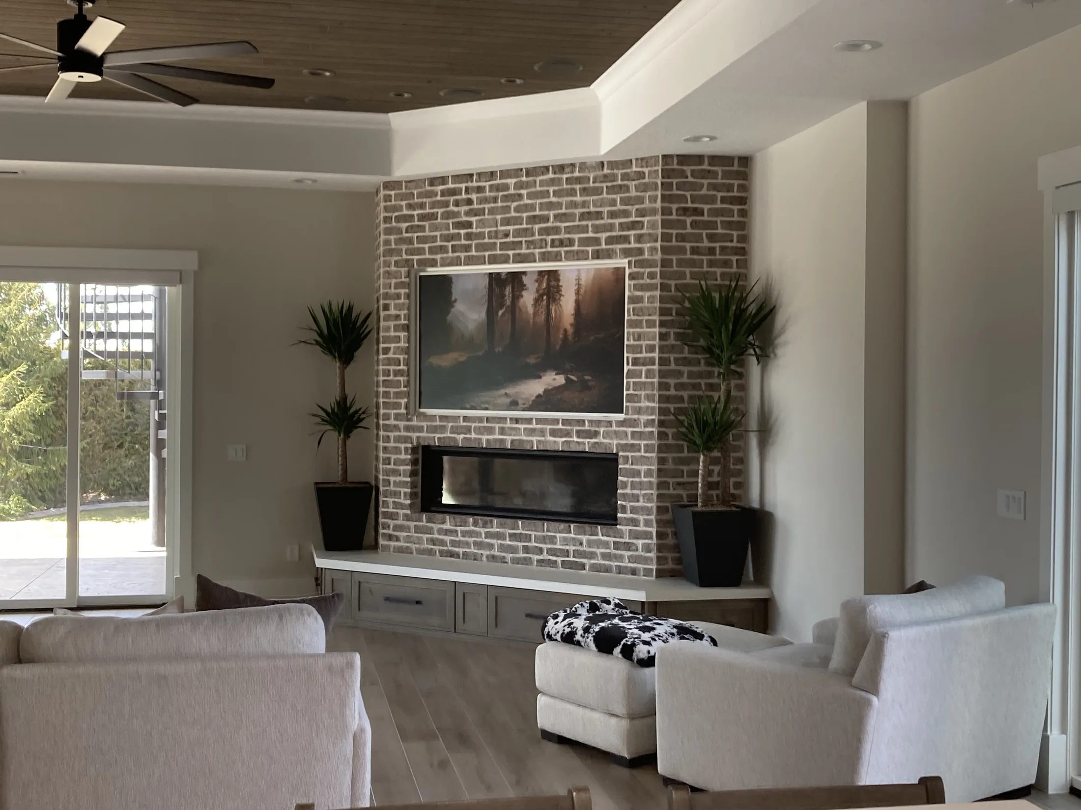 Finished gray-brick fireplace and media wall in a bright living room