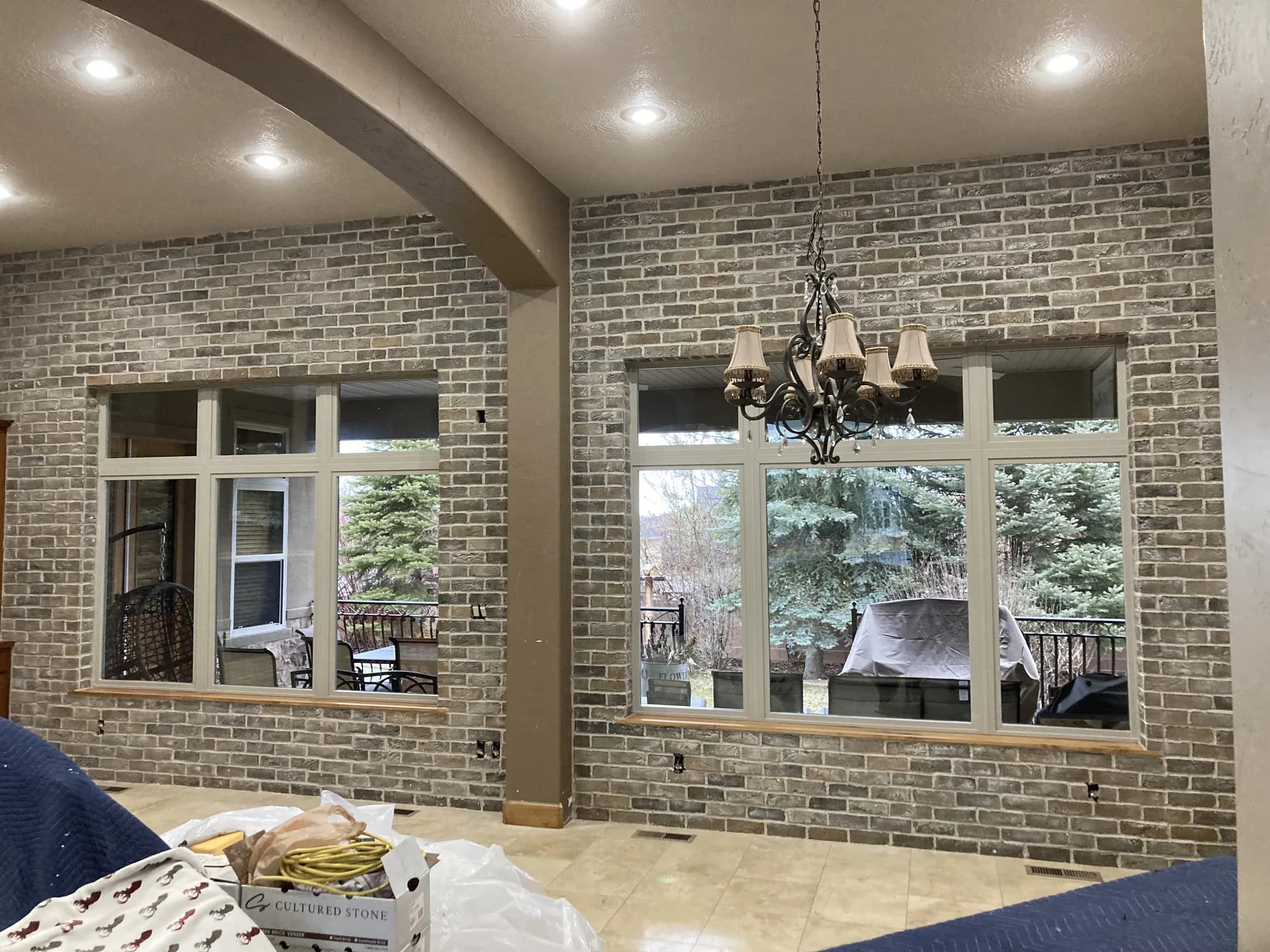 Full-height brickwork framing two large sunroom windows.
