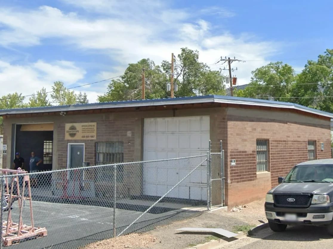 Commercial brick building entrance during exterior improvements.