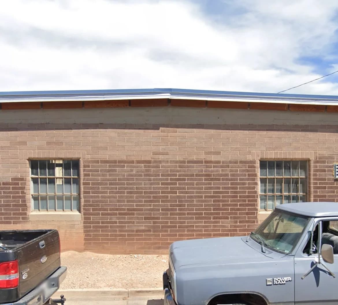 Brick commercial building facade during exterior improvements.