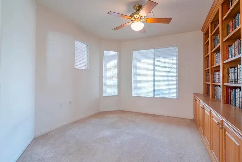 Remodeled room with bay windows and a full-height wood built-in.