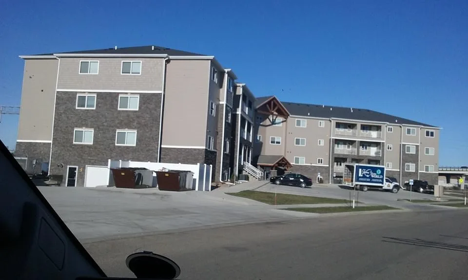 Multi-unit building exterior during renovation.
